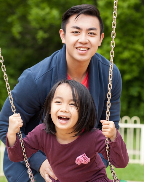 asian-family-on-a-swing-in-park-raleigh-child-support-lawyer-ellis-family