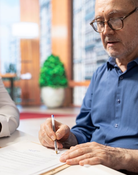 elderly-man-gives-his-signature-estate-planning-ellis-family-law-raleigh