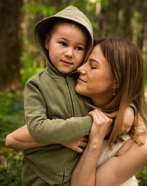 mom-with-her-son-in-the-woods-a-woman-kneels-and-2024-11-27-17-38-59-utc2