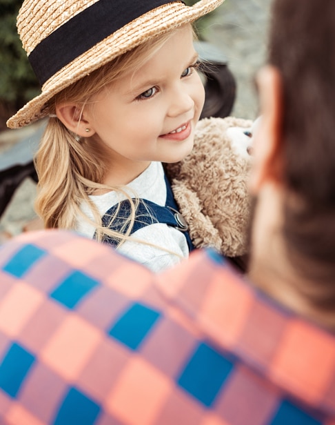 selective-focus-of-smiling-little-girl-in-straw-hat-child-custody-lawyers-ellis-family-raleigh