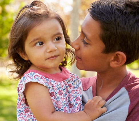 smiling-boy-carrying-his-little-sister-chapel-hill-child-support-ellis-family