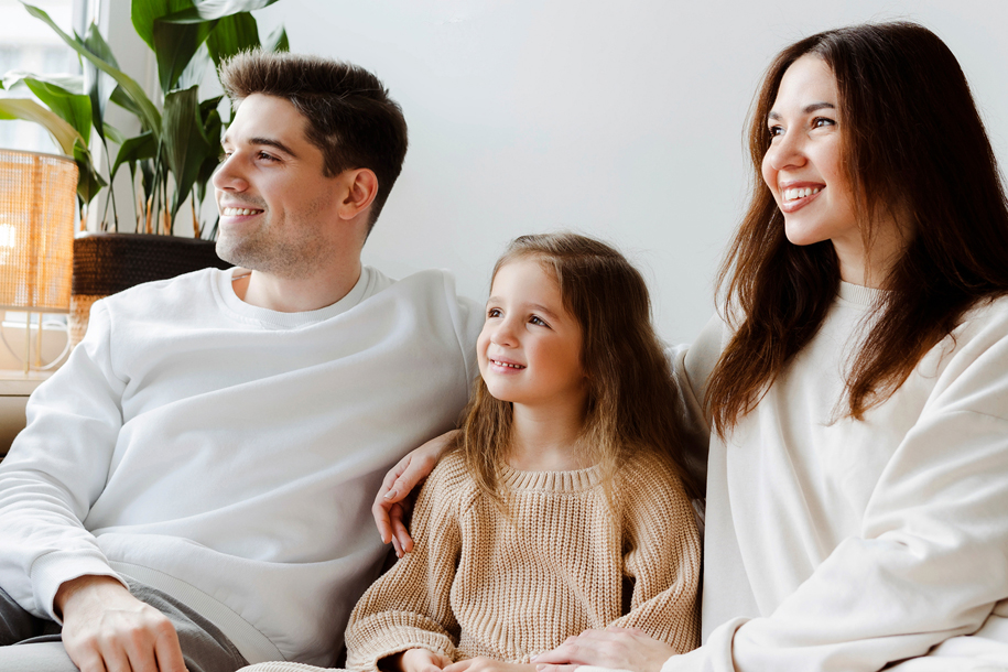 smiling-parents-and-little-daughter-watching-tv-raleigh-Ellis-Family-law