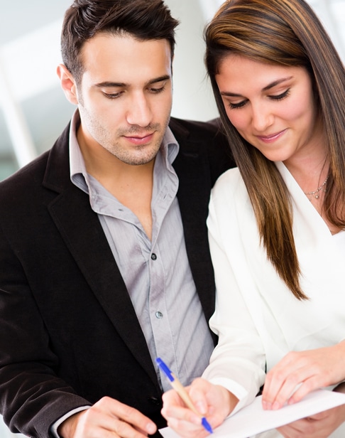 successful-business-couple-signing-a-document-ellis-family-law-prenup
