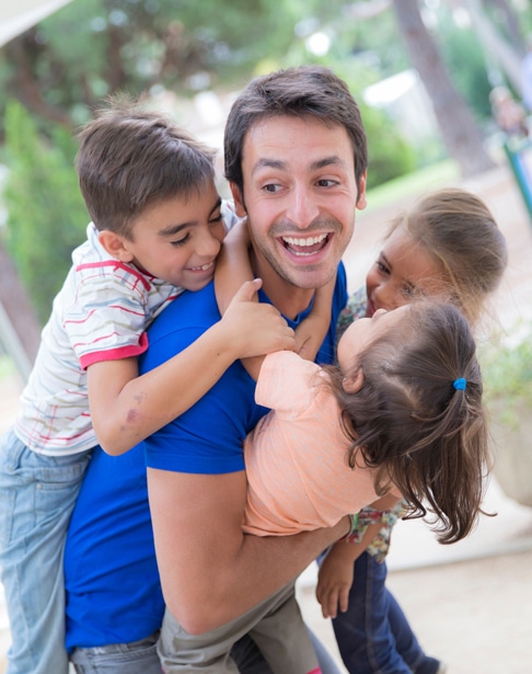 young-man-playing-with-three-children-raleigh-visitation-lawyer-ellis-family
