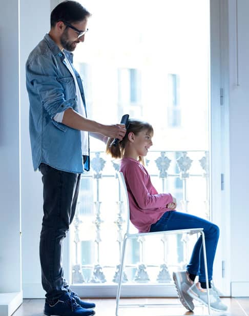 handsome-young-father-making-a-ponytail-to-his-daughter-child-support-ellis-family-law-wake-forest