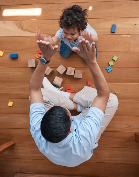 high-five-toys-and-top-view-of-father-with-baby-child-visitation-wake-forest-ellis-family-lawyers