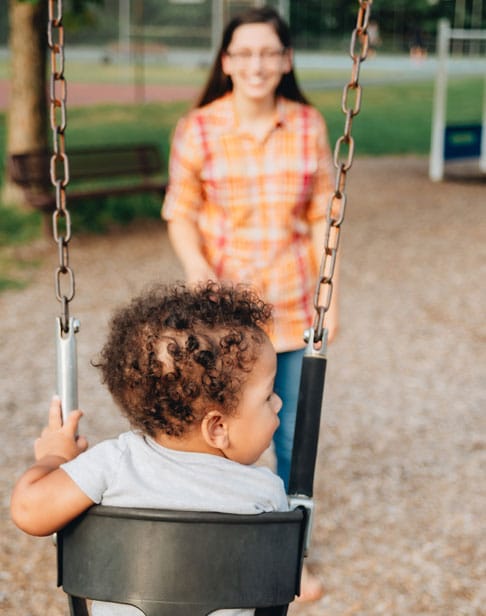 mother-at-park-playing-with-her-baby-son-child-support-ellis-family-law-wake-forest