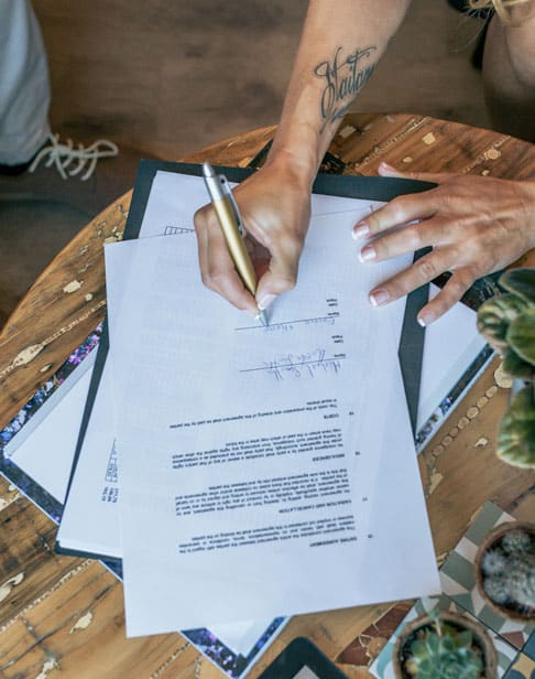 top-view-of-woman-signing-a-document-chapel-hill-prenup-lawyers-ellis-family