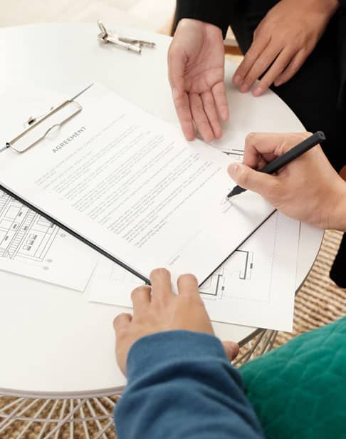 asian-couple-sign-home-contract-eillis-family-divorce-lawyer-Pittsboro