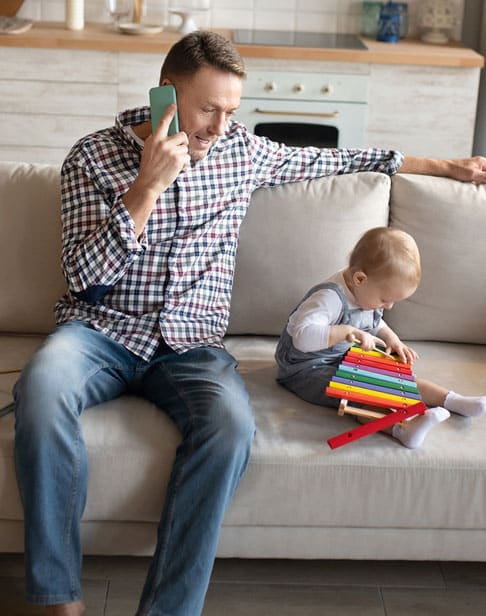 man-looking-busy-while-sitting-with-child-Pittsboro-child-support-ellis-family-law