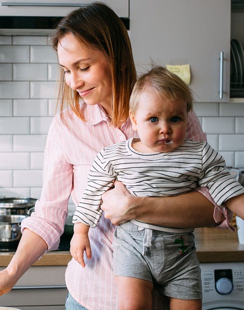 mom-feeds-a-small-child-at-home-Pittsboro-child-support-ellis-family-law