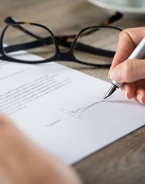 signing-a-form-eillis-family-divorce-lawyer-Pittsboro