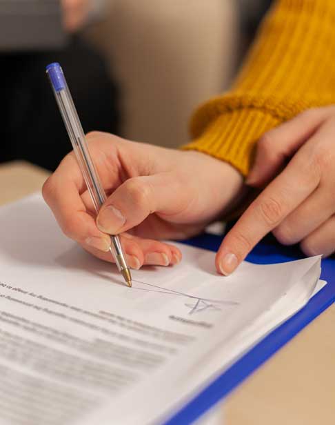 businesswoman-signing-paper-partner-hand-puts-sig-2026-01-08-02-17-13-utc-1