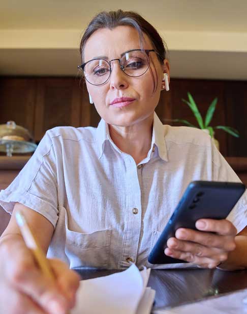 face-of-a-mature-woman-signing-papers-durham-alimony-lawyers-Ellis-family